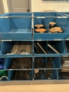 AR500 targets, base plates, welding rods, and other accessories in metal bins