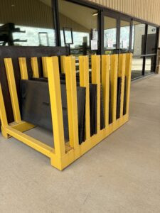 large pieces of plate in yellow outdoor rack