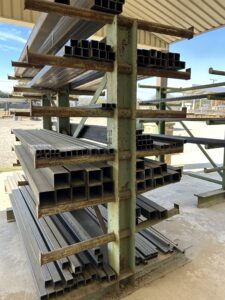 square tubing on green painted outdoor steel rack